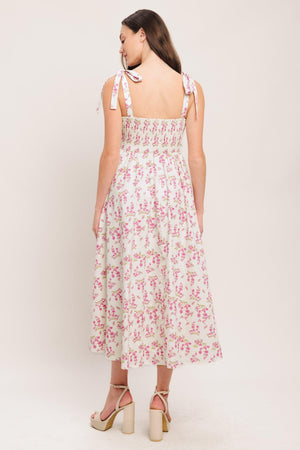 
A printed woven midi dress featuring straight neckline, shoulder tie, front button detail, corset waist with basque waistline, full skirt and smocked back

Details:

Self : 100% Cotton
Lining : 100% Polyester

Size &amp; Fit

- Model is 5`8" And Wearing Size Small
- Measurements Taken From Size Small
- Approx. Length: 48"