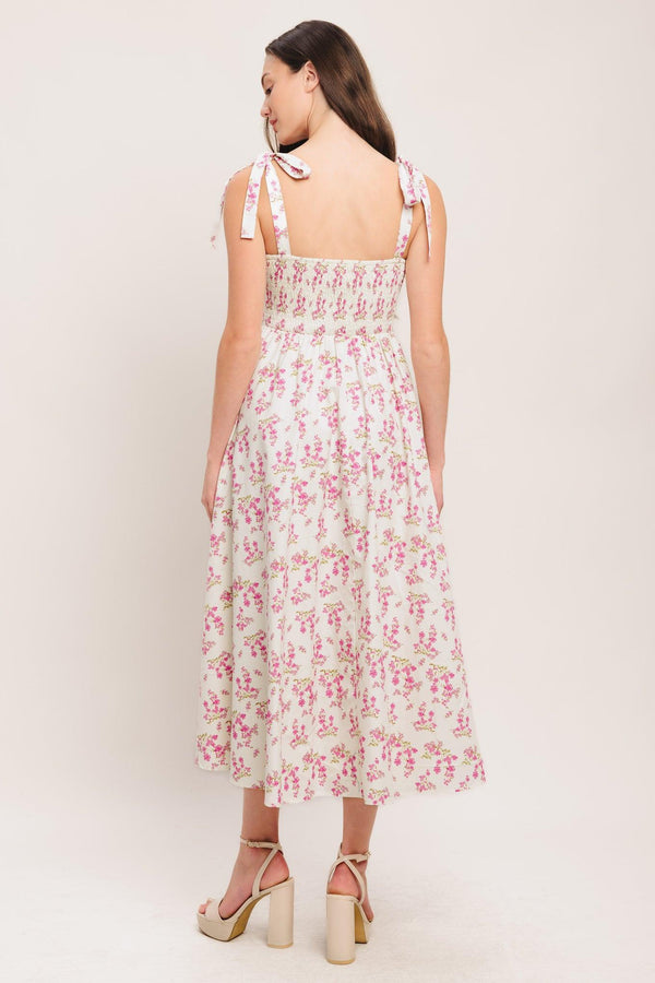 
A printed woven midi dress featuring straight neckline, shoulder tie, front button detail, corset waist with basque waistline, full skirt and smocked back

Details:

Self : 100% Cotton
Lining : 100% Polyester

Size &amp; Fit

- Model is 5`8" And Wearing Size Small
- Measurements Taken From Size Small
- Approx. Length: 48"