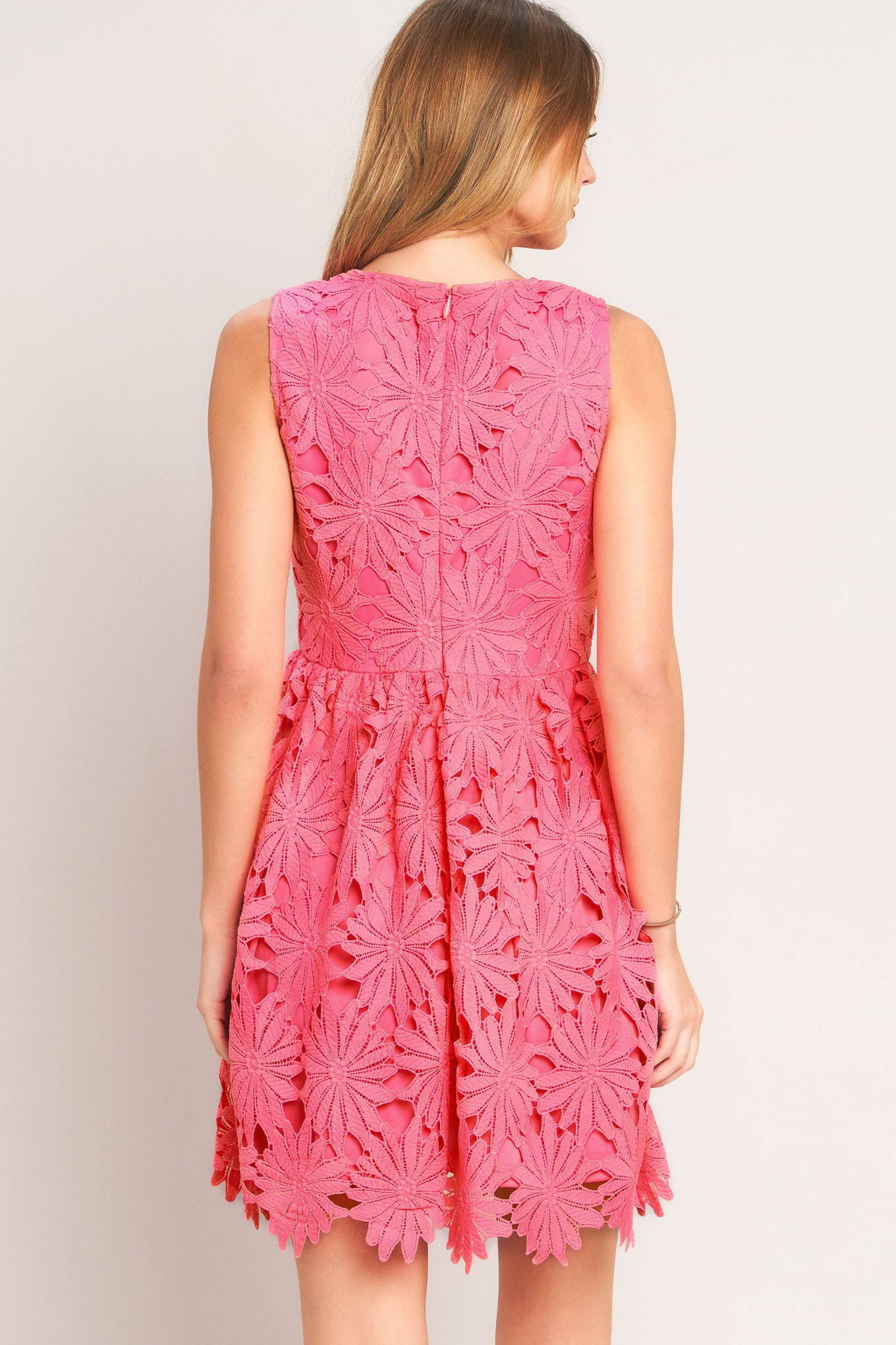 Pink lace dress on a plain background