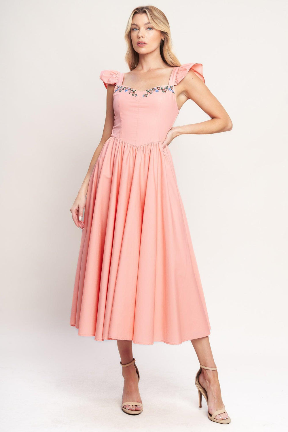A solid woven midi dress featuring sweetheart neckline, short ruffle sleeve, embroidered front, basque waist, full skirt and smocked back bodice

Details:

Self: 100% Cotton

Lining: 100% Polyester

Size & Fit

-Model is 5`8" And Wearing Size Small
-Measurements Taken From Size Small
-Approx. Length: 49"