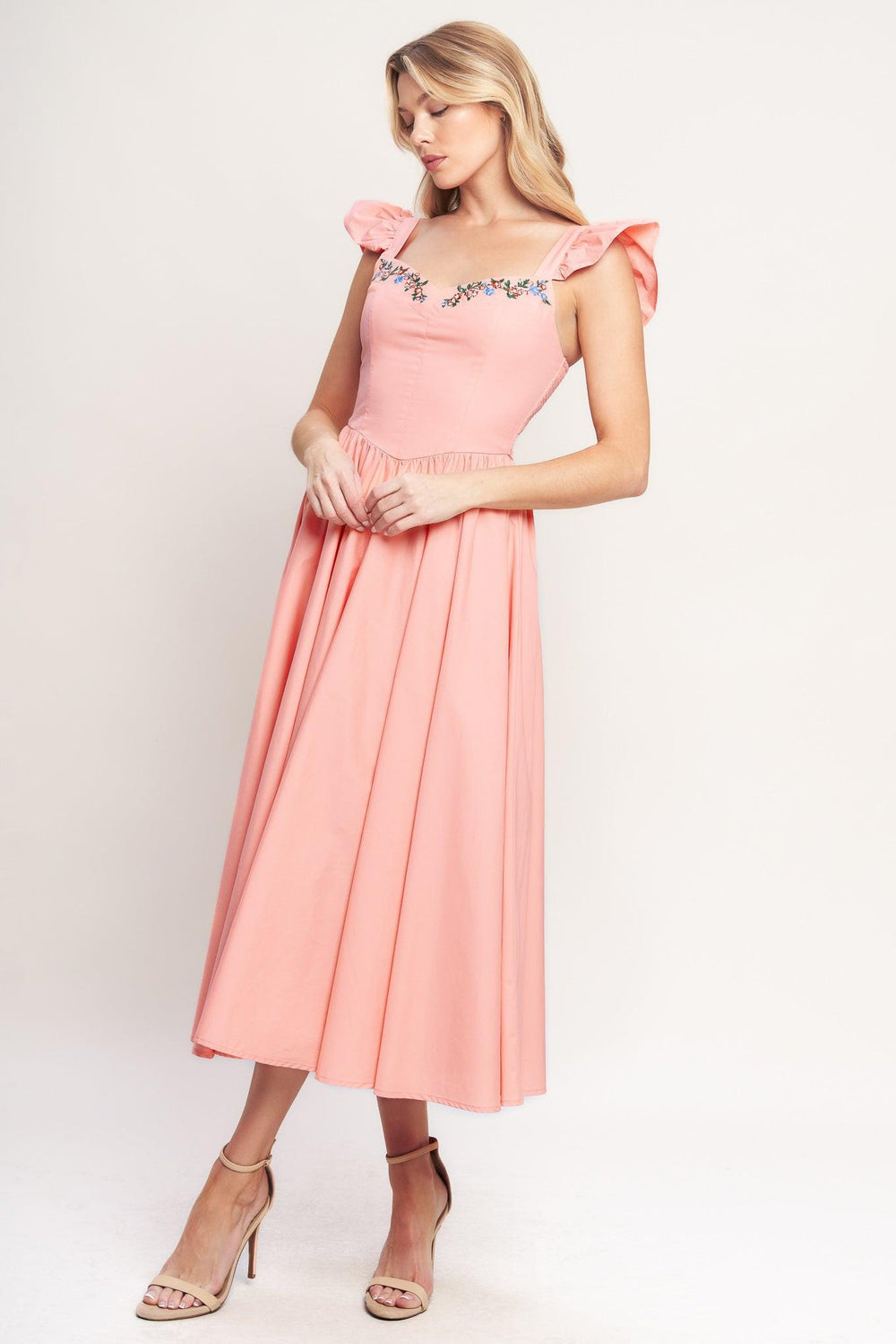 A solid woven midi dress featuring sweetheart neckline, short ruffle sleeve, embroidered front, basque waist, full skirt and smocked back bodice

Details:

Self: 100% Cotton

Lining: 100% Polyester

Size & Fit

-Model is 5`8" And Wearing Size Small
-Measurements Taken From Size Small
-Approx. Length: 49"