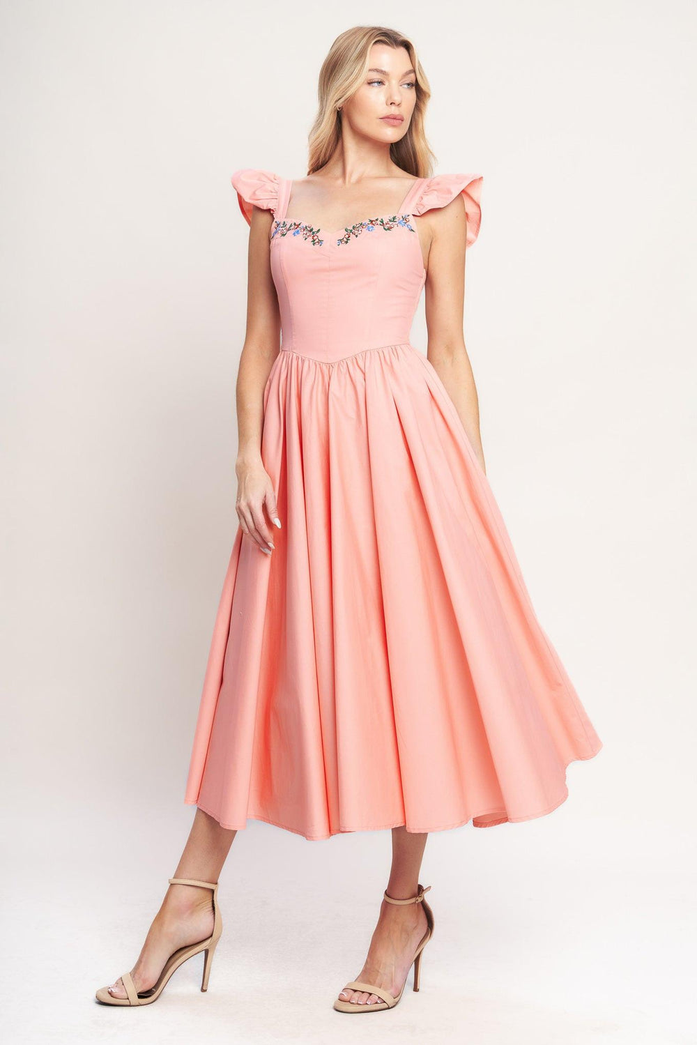 A solid woven midi dress featuring sweetheart neckline, short ruffle sleeve, embroidered front, basque waist, full skirt and smocked back bodice

Details:

Self: 100% Cotton

Lining: 100% Polyester

Size & Fit

-Model is 5`8" And Wearing Size Small
-Measurements Taken From Size Small
-Approx. Length: 49"