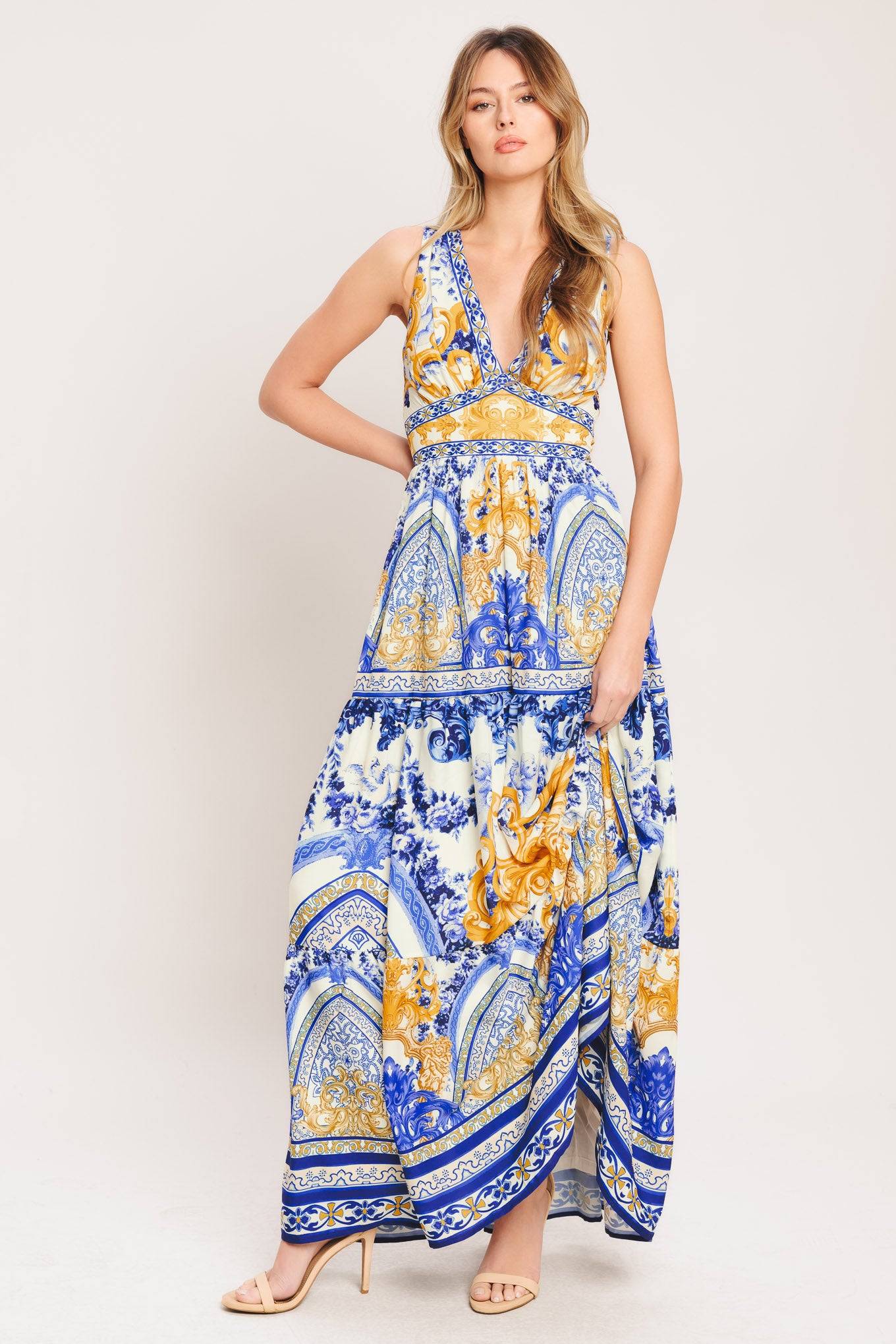 A printed woven maxi dress featuring V neckline, sleeveless, waist yoke, tiered skirt and smocked back waistband

Details:

Self: 100% Polyester

Lining: 100% Polyester

Size & Fit

-Model is 5`8" And Wearing Size Small
-Measurements Taken From Size Small
-Approx. Length: 61"