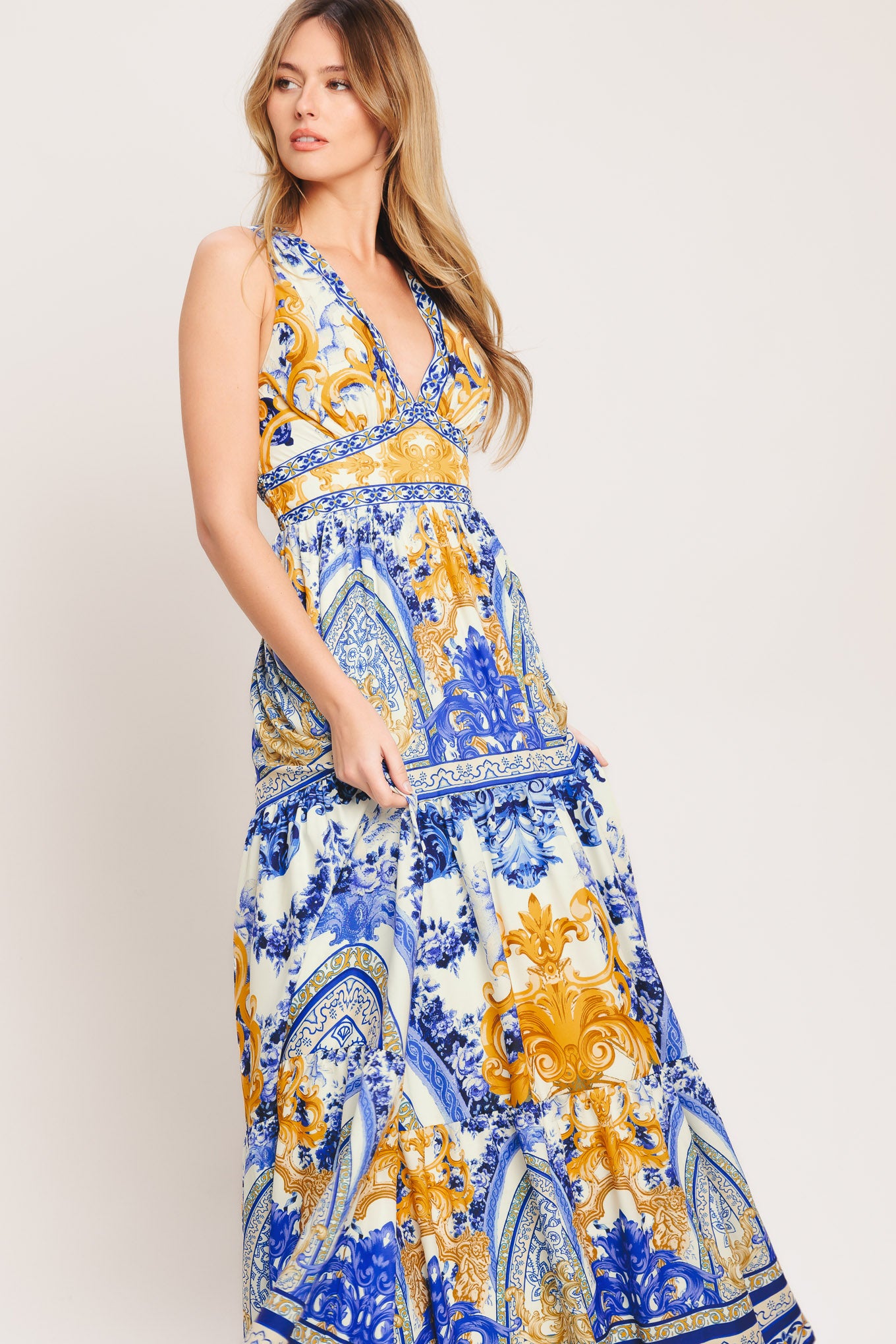 A printed woven maxi dress featuring V neckline, sleeveless, waist yoke, tiered skirt and smocked back waistband

Details:

Self: 100% Polyester

Lining: 100% Polyester

Size & Fit

-Model is 5`8" And Wearing Size Small
-Measurements Taken From Size Small
-Approx. Length: 61"