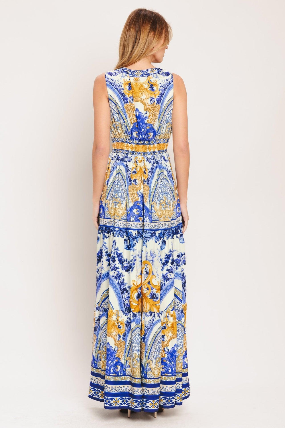 A printed woven maxi dress featuring V neckline, sleeveless, waist yoke, tiered skirt and smocked back waistband

Details:

Self: 100% Polyester

Lining: 100% Polyester

Size & Fit

-Model is 5`8" And Wearing Size Small
-Measurements Taken From Size Small
-Approx. Length: 61"