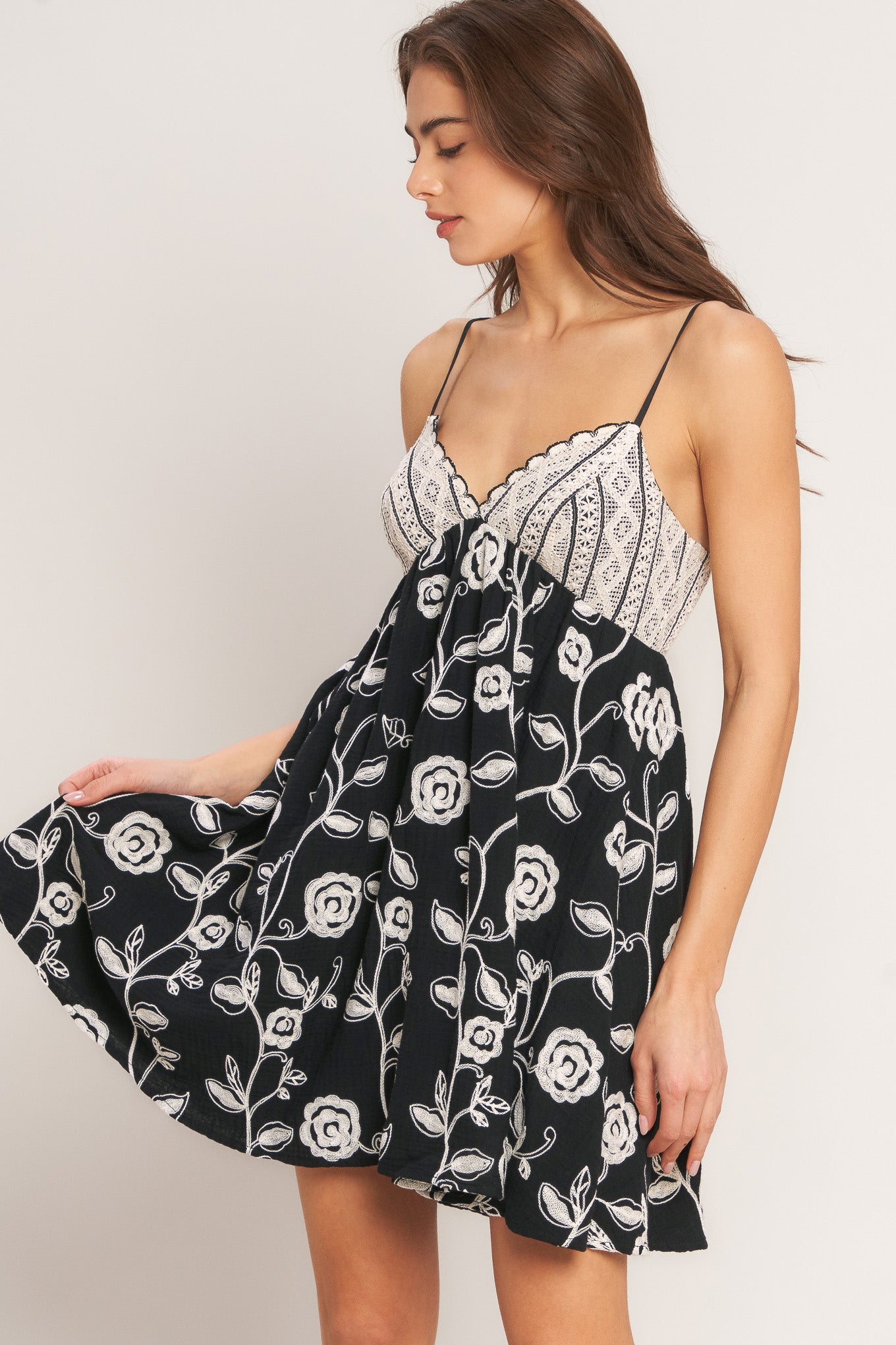 An embroidered woven mini dress with lace over bodice and back zipper closure
