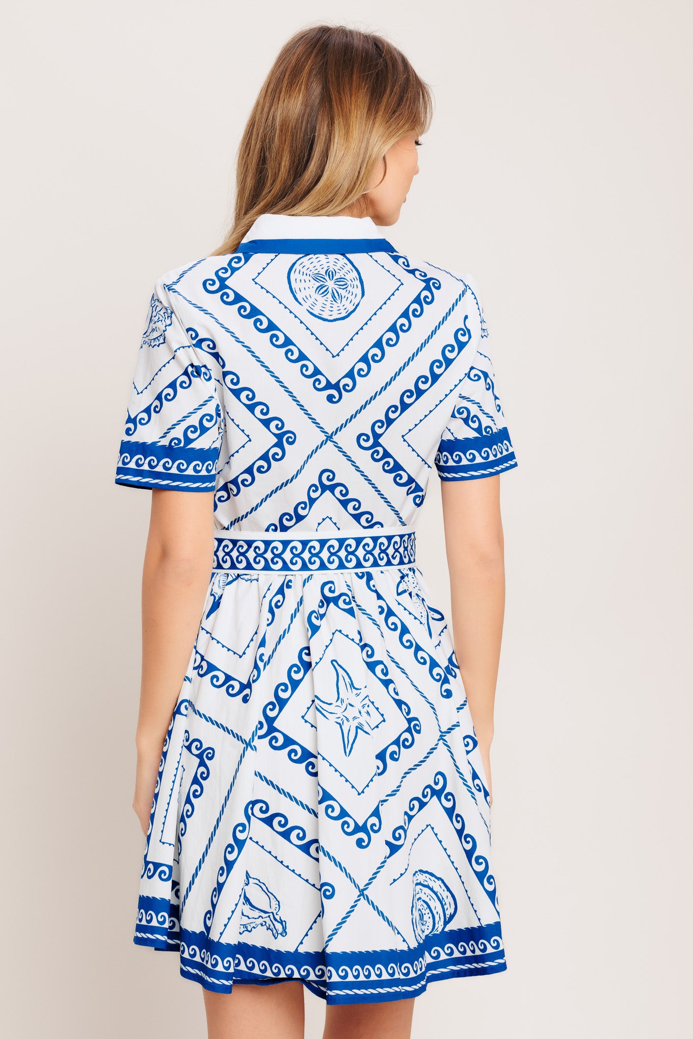 A printed woven mini dress featuring collar, short sleeve, front button down, self sash tie and full skirt

Details:

Self: 100% Cotton

Lining: 100% Polyester

Size & Fit

-Model is 5`8" And Wearing Size Small
-Measurements Taken From Size Small
-Approx. Length: 35"