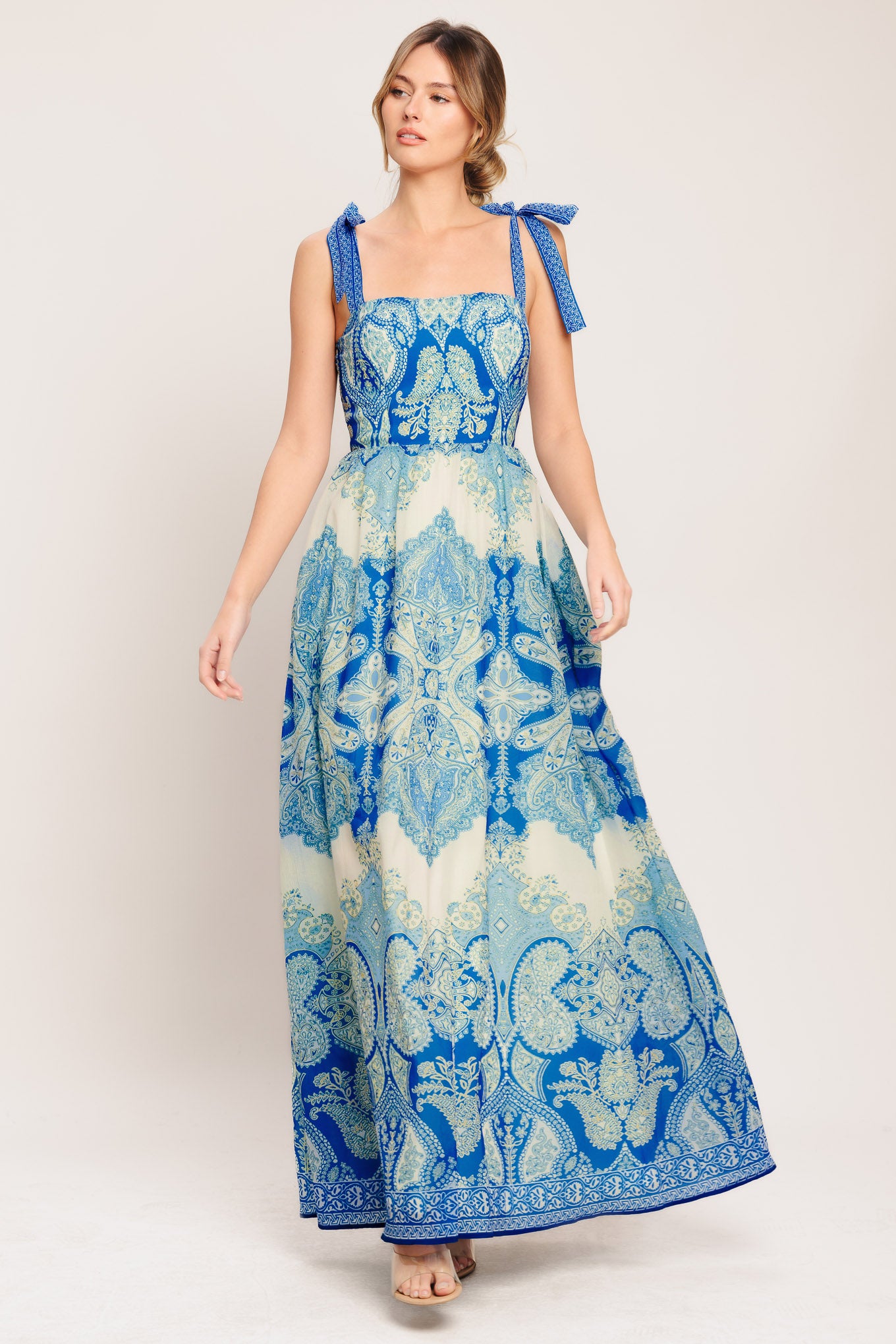 A printed woven maxi dress featuring straight neckline, shoulder ties, full skirt and smocked back bodice

Details:

Self: 100% Polyester

Lining: 100% Polyester

Size & Fit

-Model is 5`8" And Wearing Size Small
-Measurements Taken From Size Small
-Approx. Length: 60"