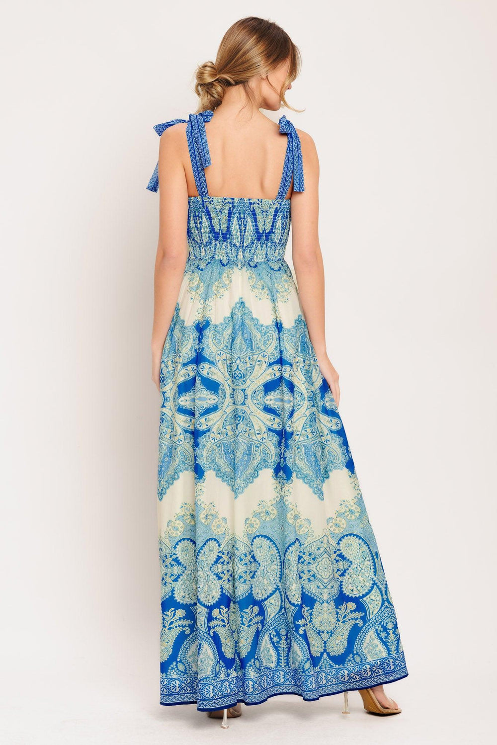 A printed woven maxi dress featuring straight neckline, shoulder ties, full skirt and smocked back bodice

Details:

Self: 100% Polyester

Lining: 100% Polyester

Size & Fit

-Model is 5`8" And Wearing Size Small
-Measurements Taken From Size Small
-Approx. Length: 60"