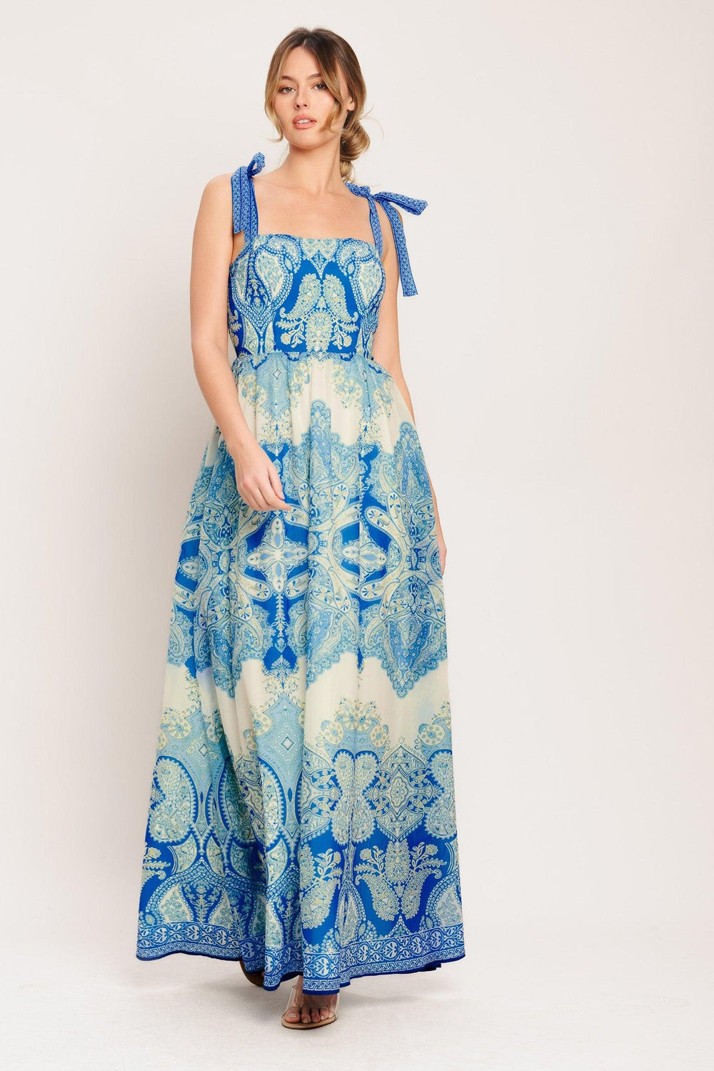 A printed woven maxi dress featuring straight neckline, shoulder ties, full skirt and smocked back bodice

Details:

Self: 100% Polyester

Lining: 100% Polyester

Size & Fit

-Model is 5`8" And Wearing Size Small
-Measurements Taken From Size Small
-Approx. Length: 60"