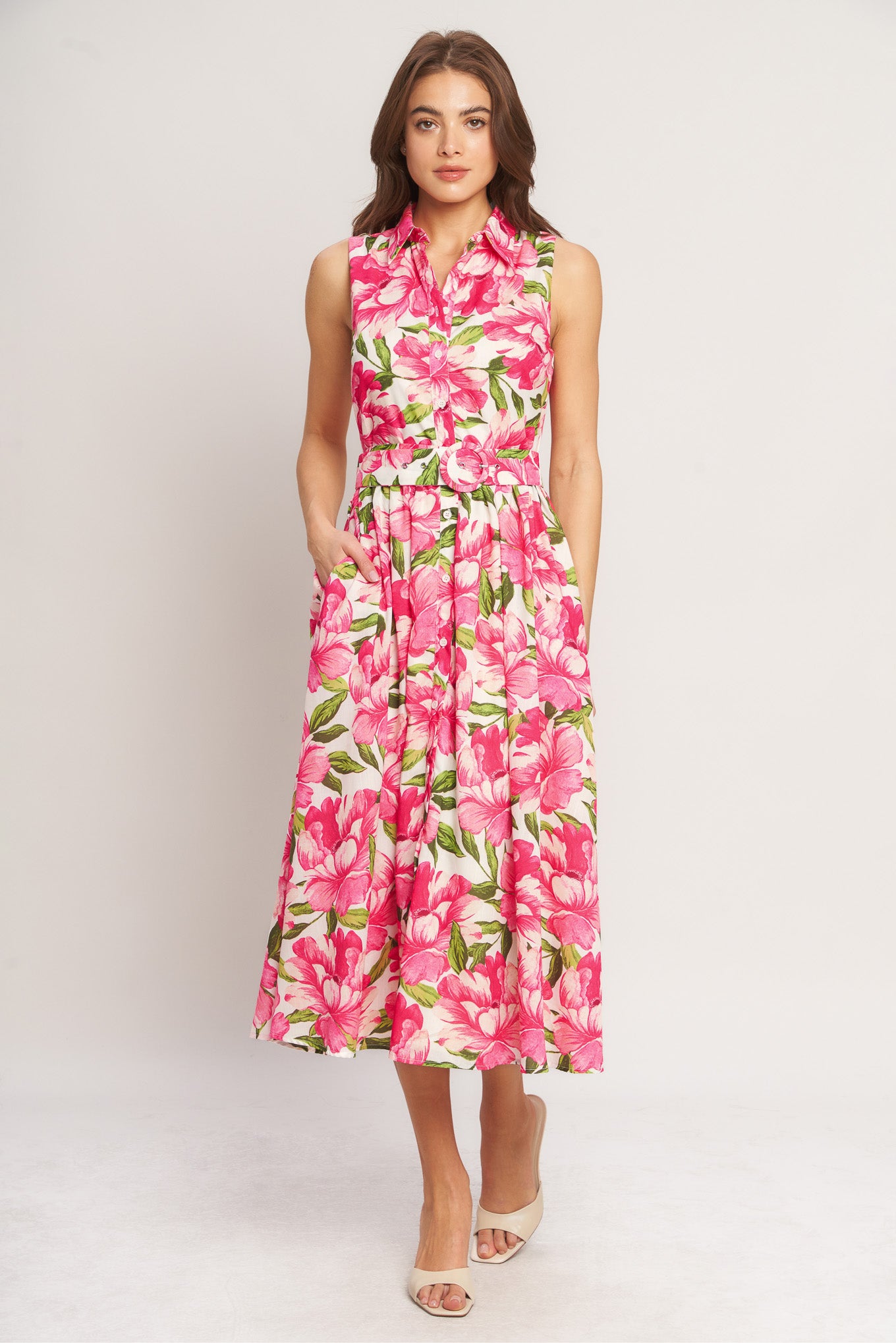 A printed woven midi dress featuring collar, sleeveless, front button down, self belt and full skirt