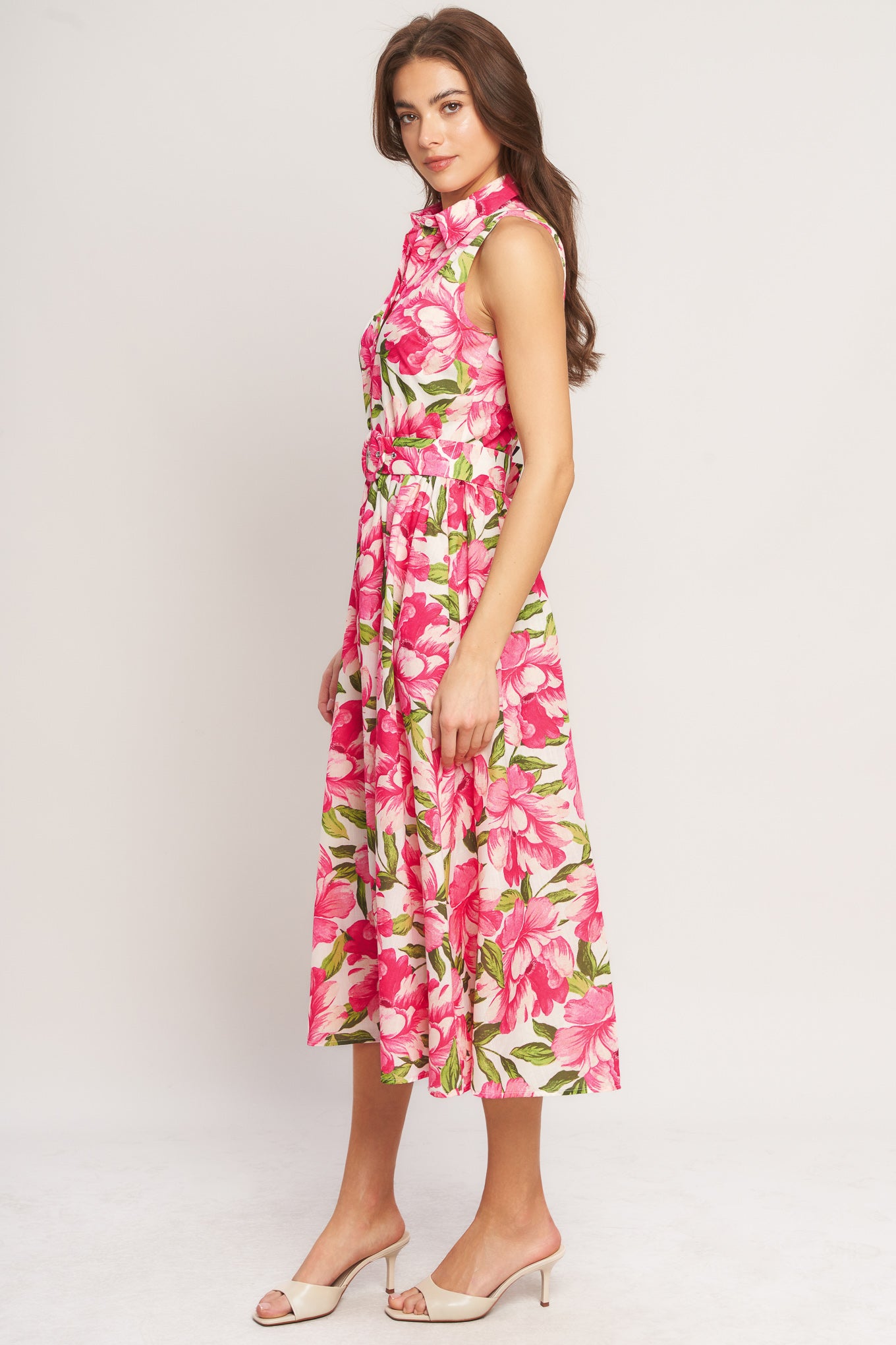 A printed woven midi dress featuring collar, sleeveless, front button down, self belt and full skirt