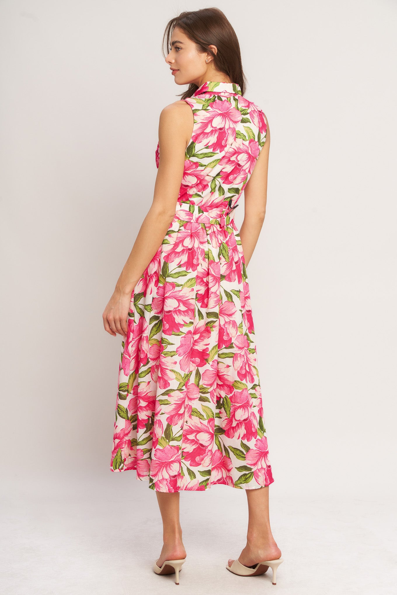 A printed woven midi dress featuring collar, sleeveless, front button down, self belt and full skirt