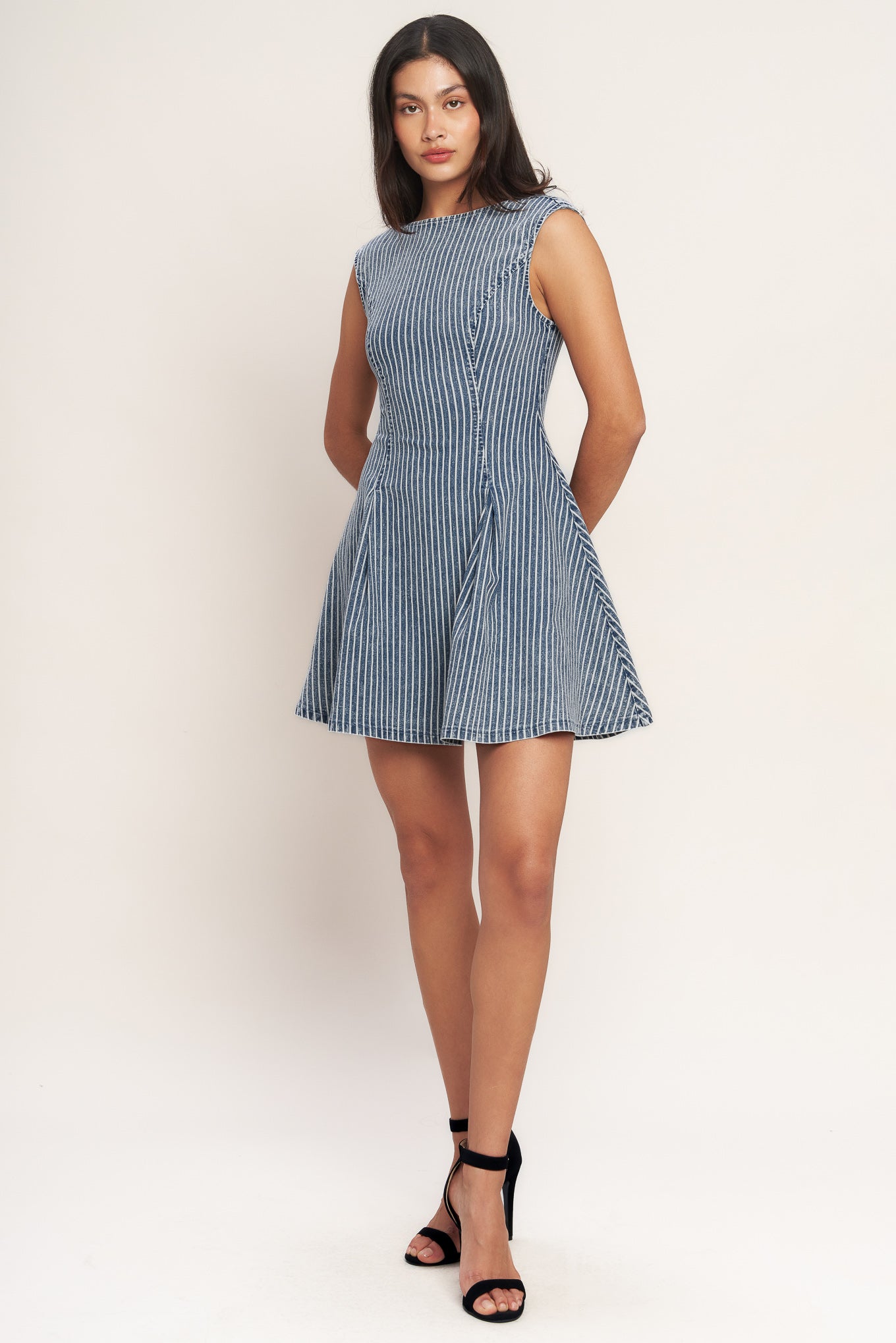
A striped denim mini dress featuring round neckline, sleeveless, circle skirt, cut out back and button zipper closure

Details:

Self : 65% Cotton, 33% Polyester, 2% Spandex

Size &amp; Fit

- Model is 5`8" And Wearing Size Small
- Measurements Taken From Size Small
- Approx. Length: 33" Flying Tomato