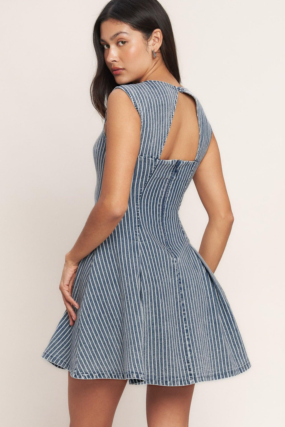 
A striped denim mini dress featuring round neckline, sleeveless, circle skirt, cut out back and button zipper closure

Details:

Self : 65% Cotton, 33% Polyester, 2% Spandex

Size &amp; Fit

- Model is 5`8" And Wearing Size Small
- Measurements Taken From Size Small
- Approx. Length: 33" Flying Tomato