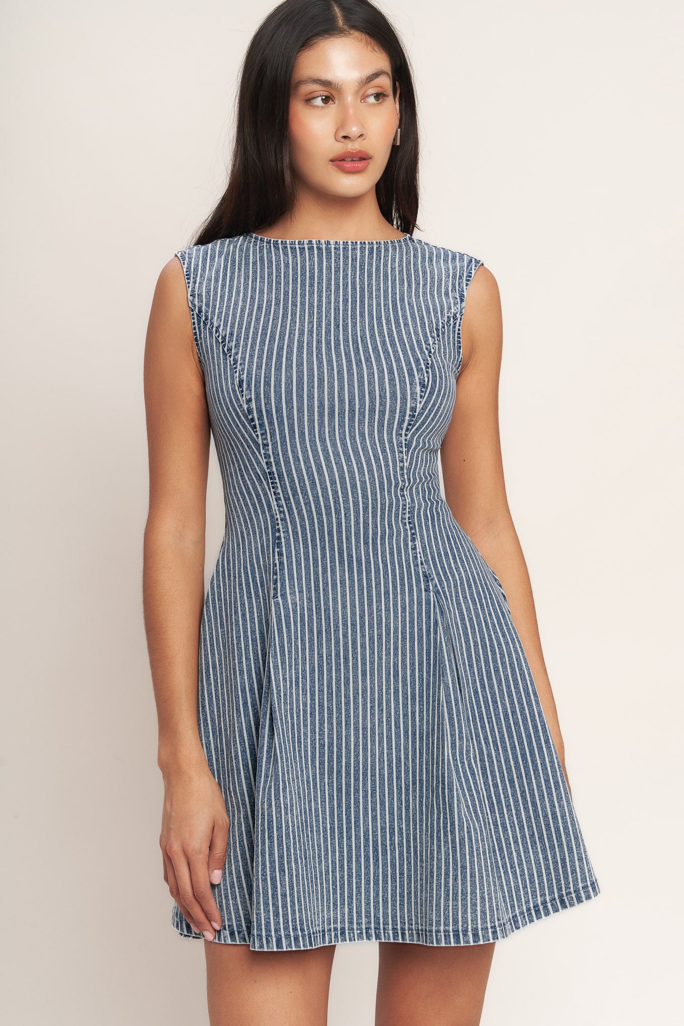 
A striped denim mini dress featuring round neckline, sleeveless, circle skirt, cut out back and button zipper closure

Details:

Self : 65% Cotton, 33% Polyester, 2% Spandex

Size &amp; Fit

- Model is 5`8" And Wearing Size Small
- Measurements Taken From Size Small
- Approx. Length: 33" Flying Tomato