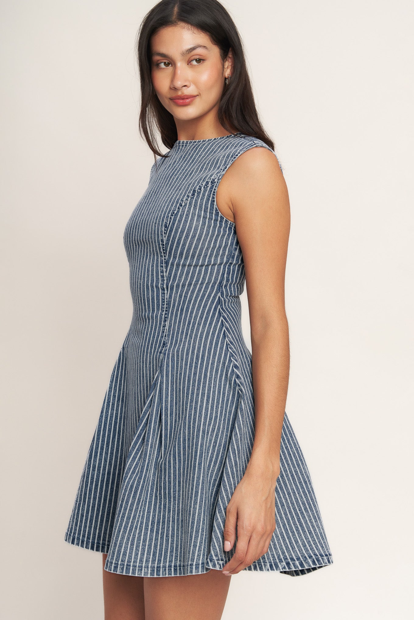 
A striped denim mini dress featuring round neckline, sleeveless, circle skirt, cut out back and button zipper closure

Details:

Self : 65% Cotton, 33% Polyester, 2% Spandex

Size &amp; Fit

- Model is 5`8" And Wearing Size Small
- Measurements Taken From Size Small
- Approx. Length: 33" Flying Tomato