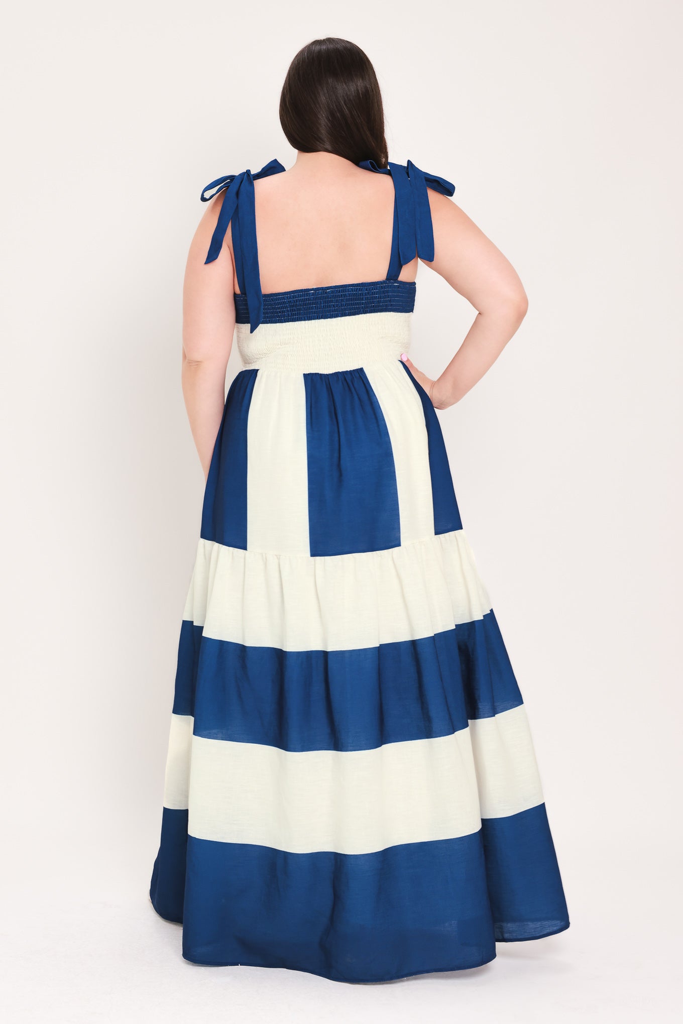 Woman wearing a blue and white dress with bow straps | Flying Tomato Curve