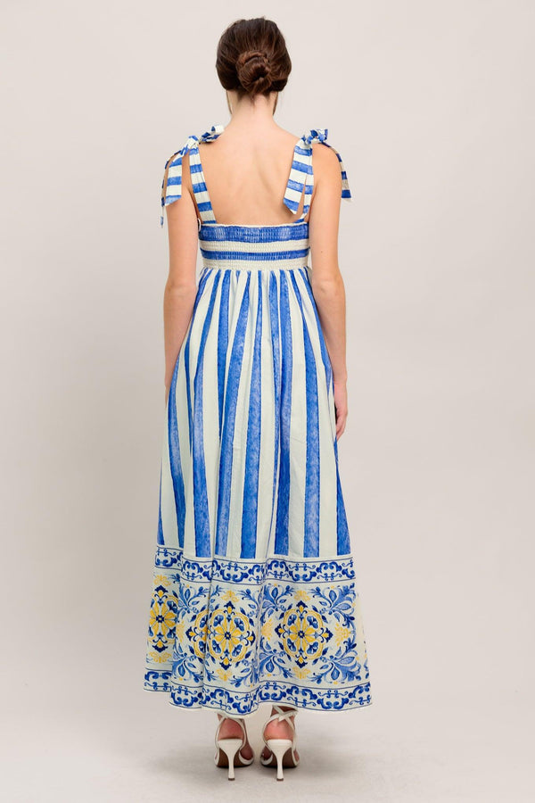 
A printed woven midi dress featuring straight neckline, shoulder tie and smocked back bodice

Details:

Self : 100% Cotton
Lining : 100% Polyester

Size &amp; Fit

- Model is 5`8" And Wearing Size Small
- Measurements Taken From Size Small
- Approx. Length: 52" Flying Tomato