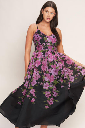 A printed woven midi dress featuring cami top, wide waist band, full skirt and back zipper closure