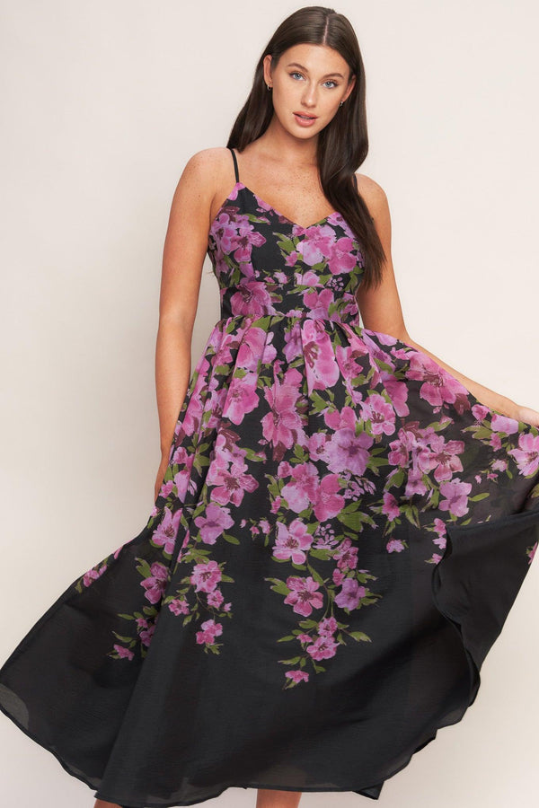 A printed woven midi dress featuring cami top, wide waist band, full skirt and back zipper closure