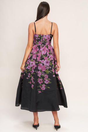 A printed woven midi dress featuring cami top, wide waist band, full skirt and back zipper closure