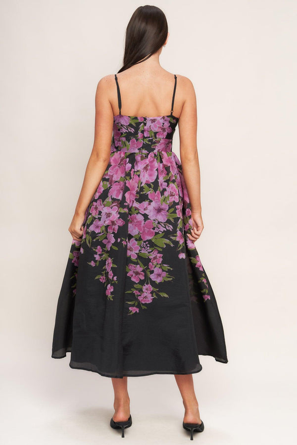 A printed woven midi dress featuring cami top, wide waist band, full skirt and back zipper closure