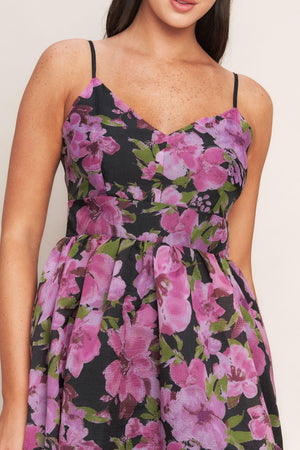 A printed woven midi dress featuring cami top, wide waist band, full skirt and back zipper closure