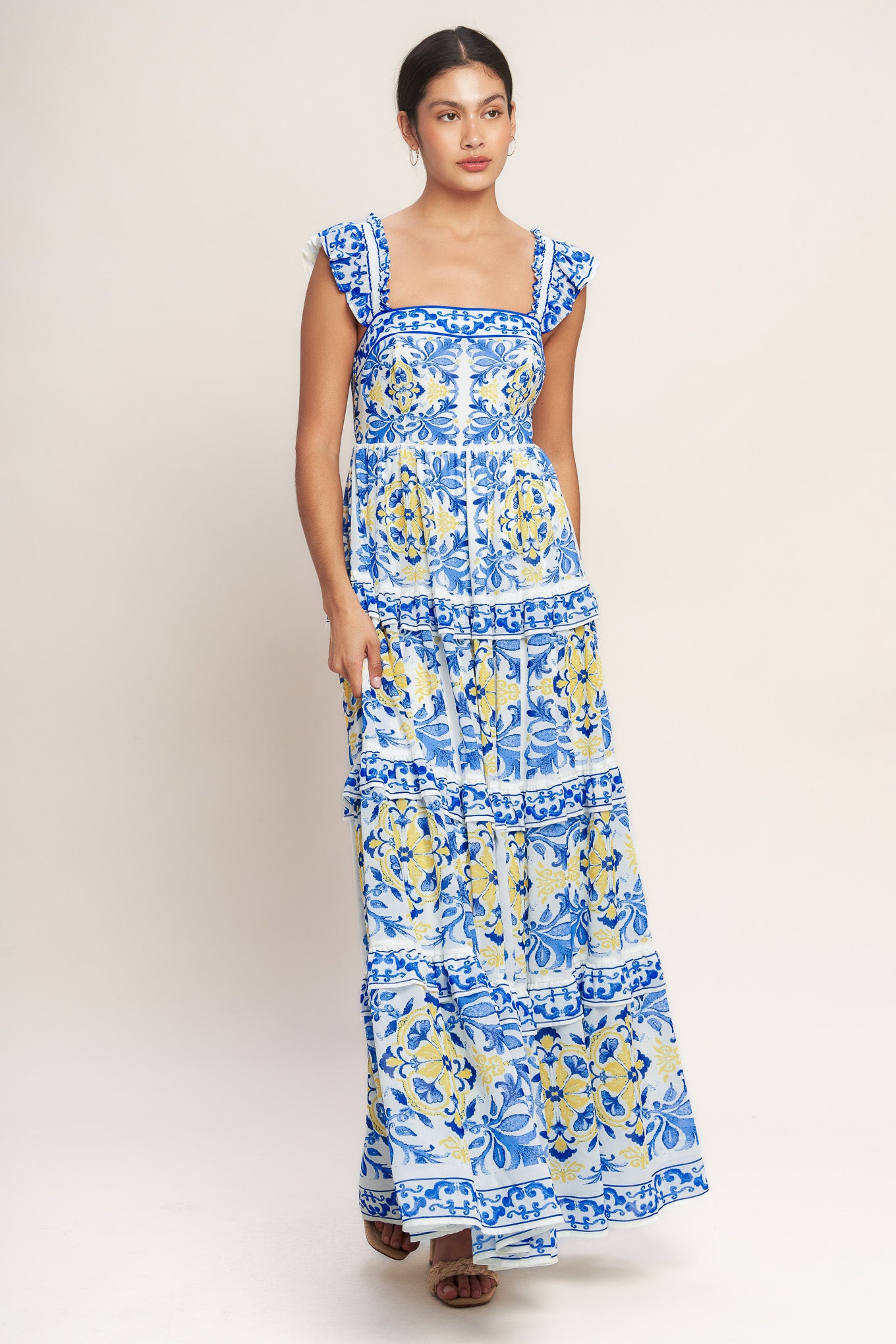 
A printed woven maxi dress featuring straight neckline, ruffle sleeve, tiered skirt with ruffle inset and smocked back bodice

Details:

Self : 100% Polyester
Lining : 100% Polyester

Size &amp; Fit

- Model is 5`8" And Wearing Size Small
- Measurements Taken From Size Small
- Approx. Length: 59" Flying Tomato