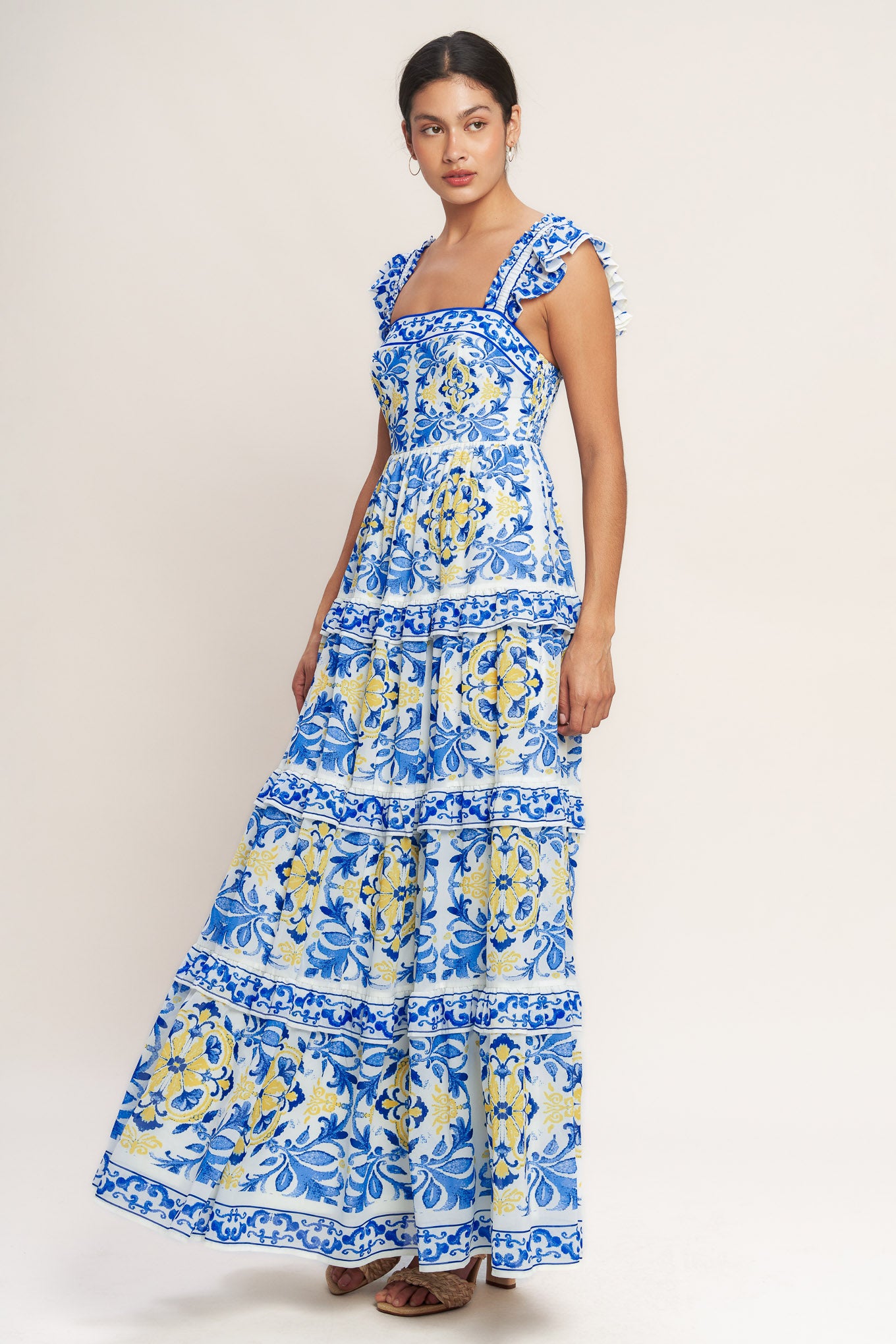 
A printed woven maxi dress featuring straight neckline, ruffle sleeve, tiered skirt with ruffle inset and smocked back bodice

Details:

Self : 100% Polyester
Lining : 100% Polyester

Size &amp; Fit

- Model is 5`8" And Wearing Size Small
- Measurements Taken From Size Small
- Approx. Length: 59" Flying Tomato