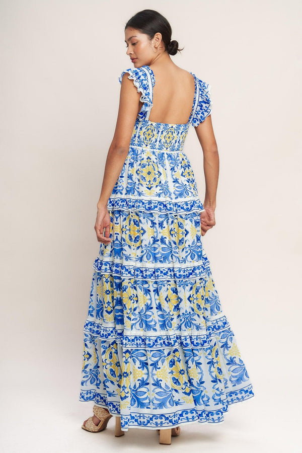 
A printed woven maxi dress featuring straight neckline, ruffle sleeve, tiered skirt with ruffle inset and smocked back bodice

Details:

Self : 100% Polyester
Lining : 100% Polyester

Size &amp; Fit

- Model is 5`8" And Wearing Size Small
- Measurements Taken From Size Small
- Approx. Length: 59" Flying Tomato