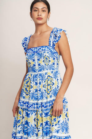 
A printed woven maxi dress featuring straight neckline, ruffle sleeve, tiered skirt with ruffle inset and smocked back bodice

Details:

Self : 100% Polyester
Lining : 100% Polyester

Size &amp; Fit

- Model is 5`8" And Wearing Size Small
- Measurements Taken From Size Small
- Approx. Length: 59" Flying Tomato