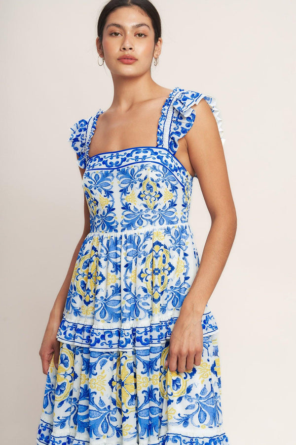 
A printed woven maxi dress featuring straight neckline, ruffle sleeve, tiered skirt with ruffle inset and smocked back bodice

Details:

Self : 100% Polyester
Lining : 100% Polyester

Size &amp; Fit

- Model is 5`8" And Wearing Size Small
- Measurements Taken From Size Small
- Approx. Length: 59" Flying Tomato
