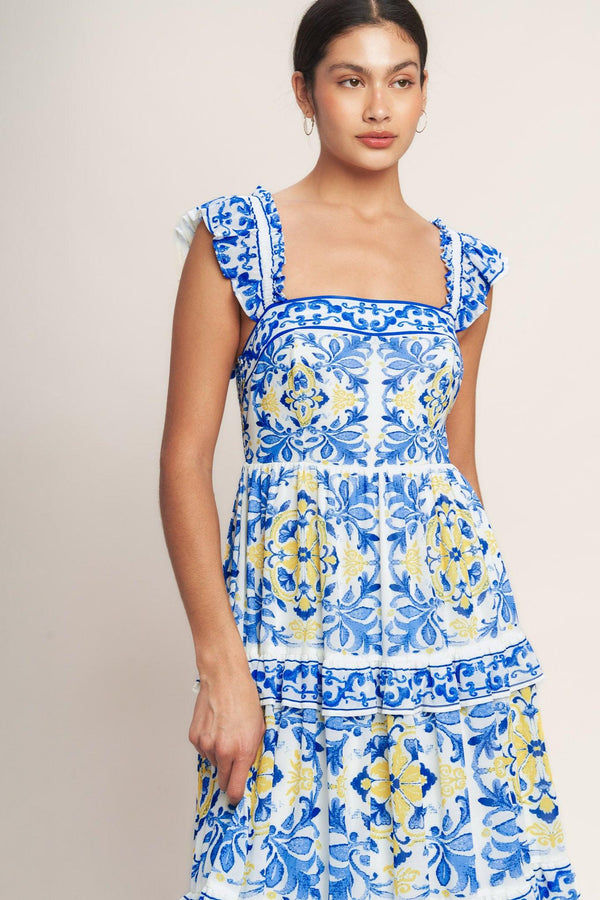 
A printed woven maxi dress featuring straight neckline, ruffle sleeve, tiered skirt with ruffle inset and smocked back bodice

Details:

Self : 100% Polyester
Lining : 100% Polyester

Size &amp; Fit

- Model is 5`8" And Wearing Size Small
- Measurements Taken From Size Small
- Approx. Length: 59" Flying Tomato