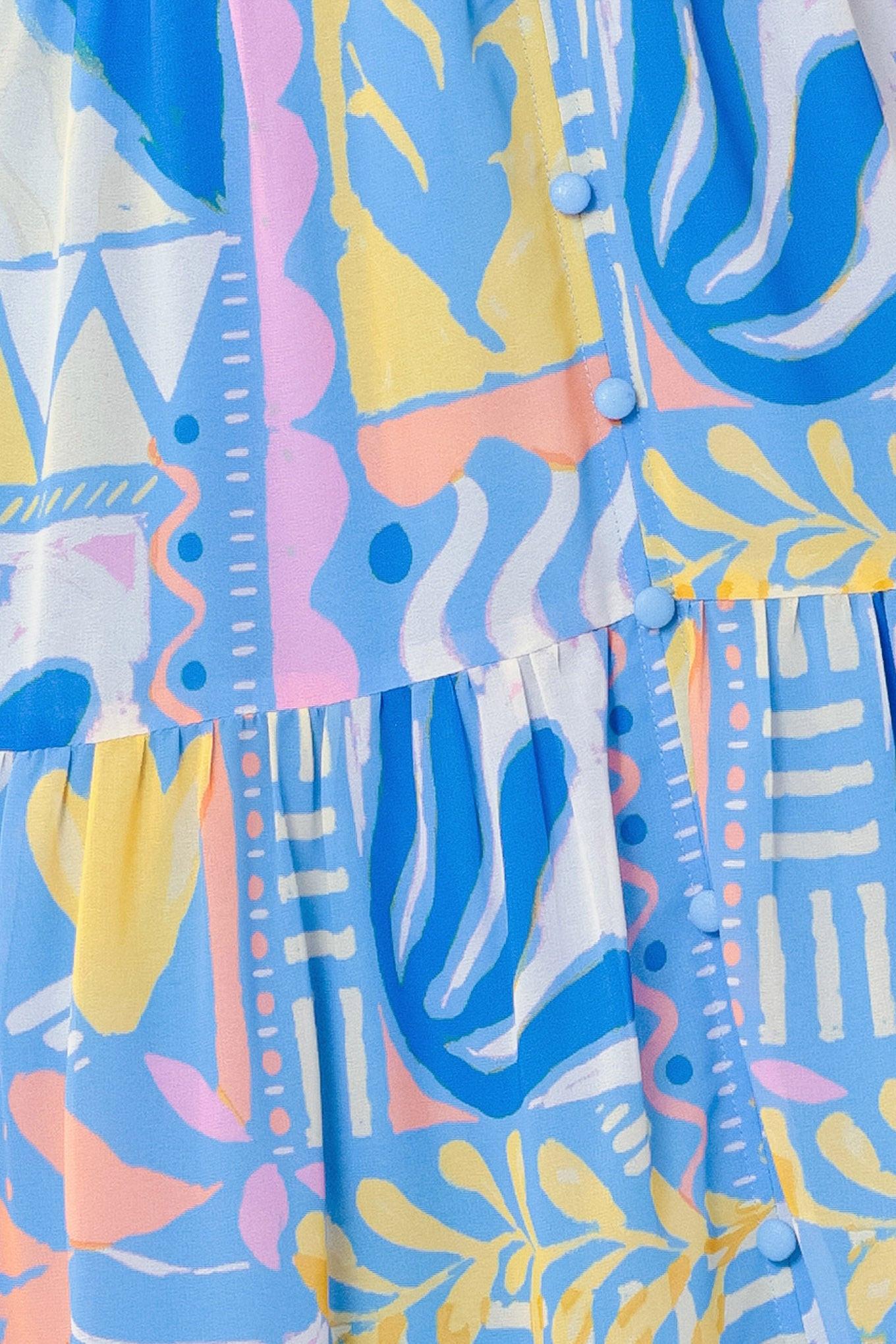 Colorful abstract patterned shirt with blue, yellow, and pink design.