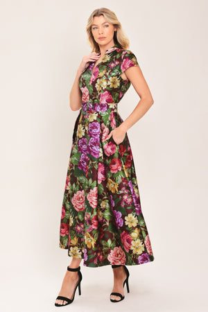 Woman wearing a floral printed woven midi dress featuring high collar with V front, short sleeve, self belt, full skirt and back zipper closure | Flying Tomato