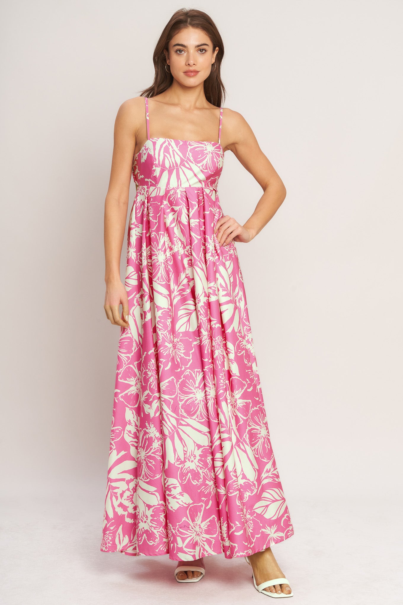 A printed woven maxi dress featuring straight neckline, straps and bare back with tie closure