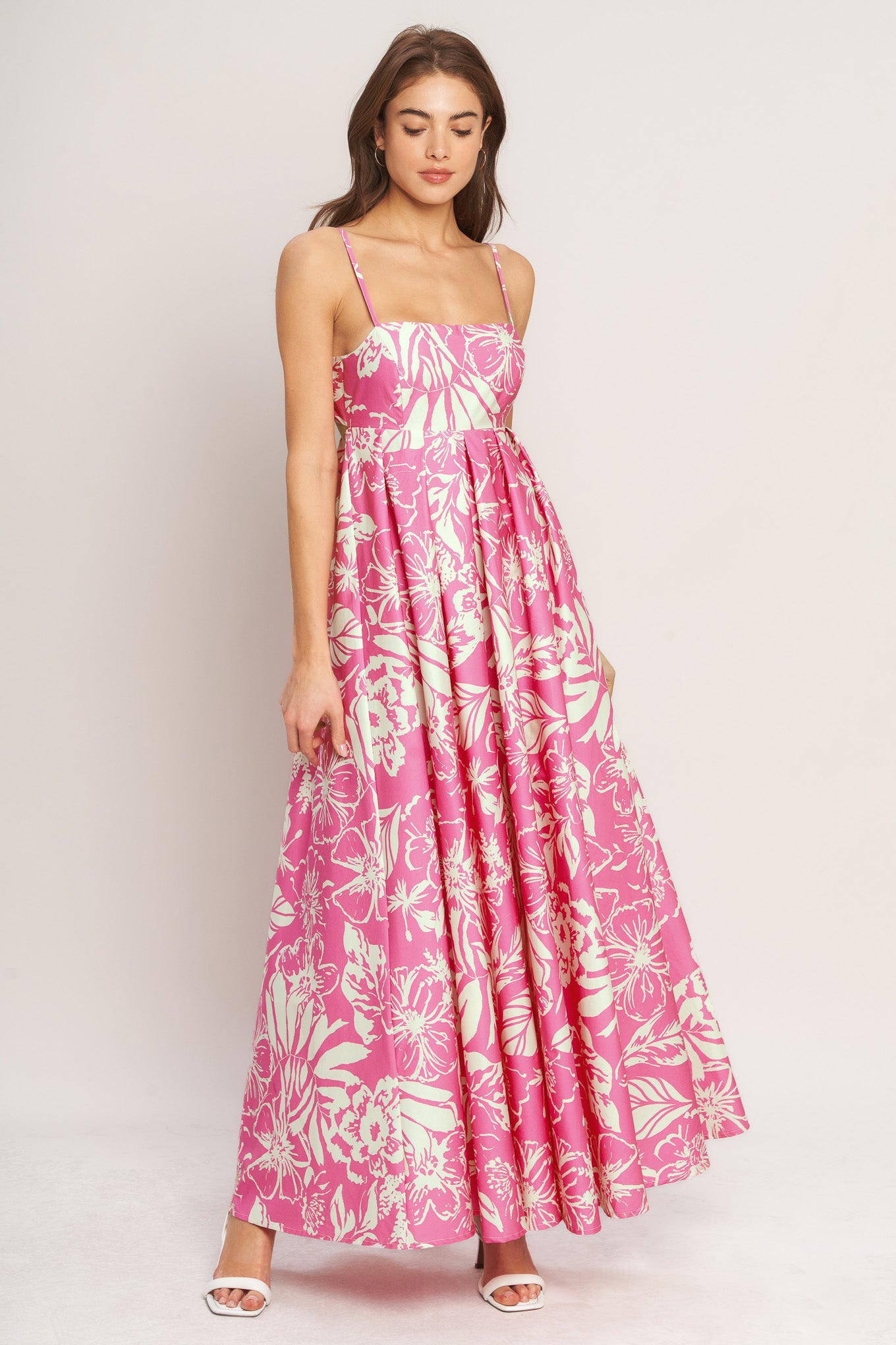 A printed woven maxi dress featuring straight neckline, straps and bare back with tie closure