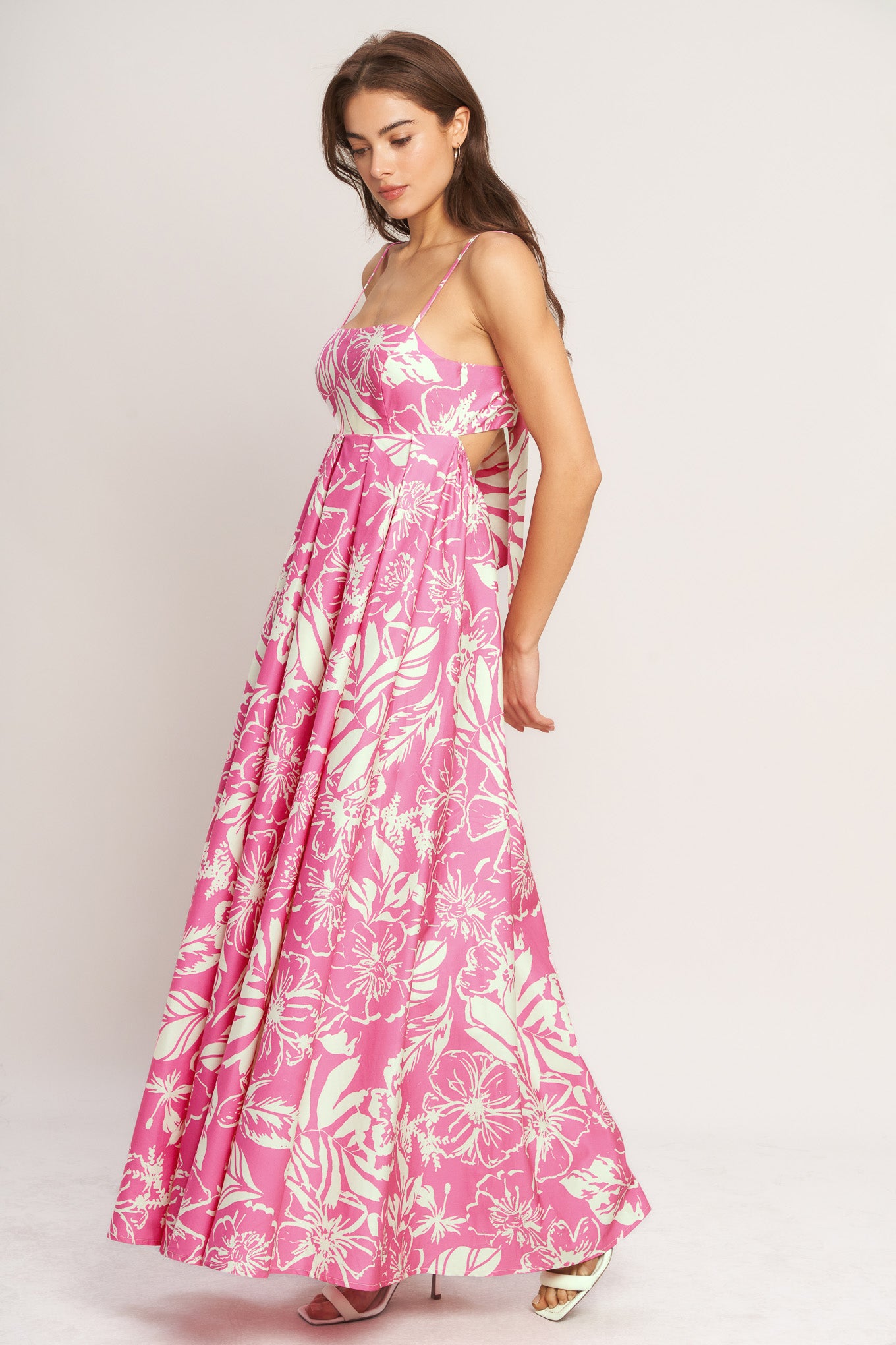 A printed woven maxi dress featuring straight neckline, straps and bare back with tie closure