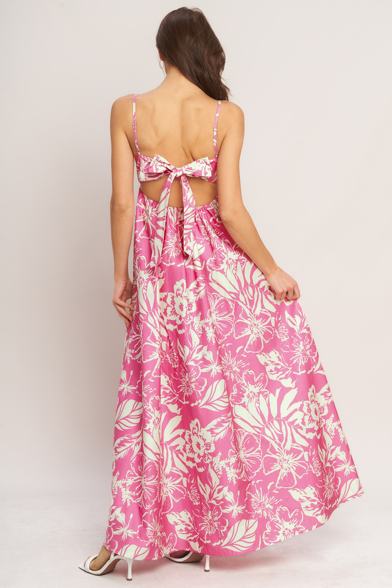 A printed woven maxi dress featuring straight neckline, straps and bare back with tie closure