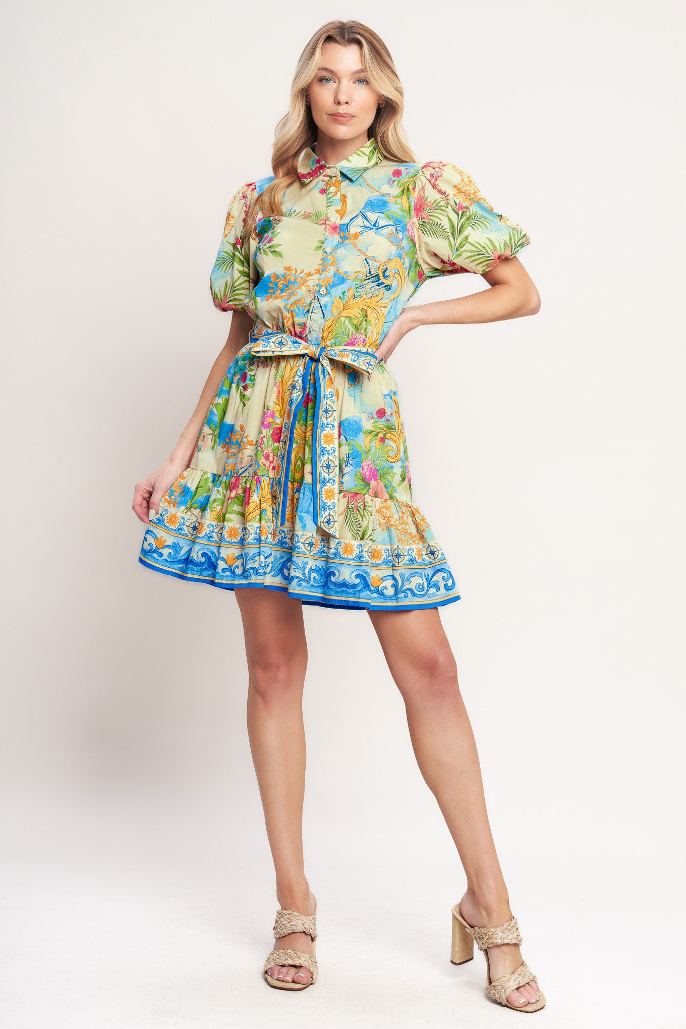 A printed woven mini dress featuring collar, short puff sleeve, front button down, elasticized waist with self sash tie and ruffle hem

Details:

Self: 100% Cotton

Size & Fit

-Model is 5`8" And Wearing Size Small
-Measurements Taken From Size Small
-Approx. Length: 36"