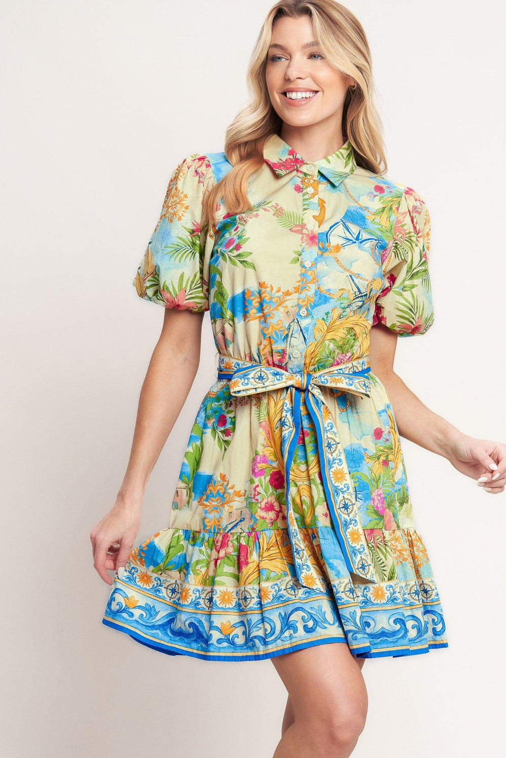 A printed woven mini dress featuring collar, short puff sleeve, front button down, elasticized waist with self sash tie and ruffle hem

Details:

Self: 100% Cotton

Size & Fit

-Model is 5`8" And Wearing Size Small
-Measurements Taken From Size Small
-Approx. Length: 36"