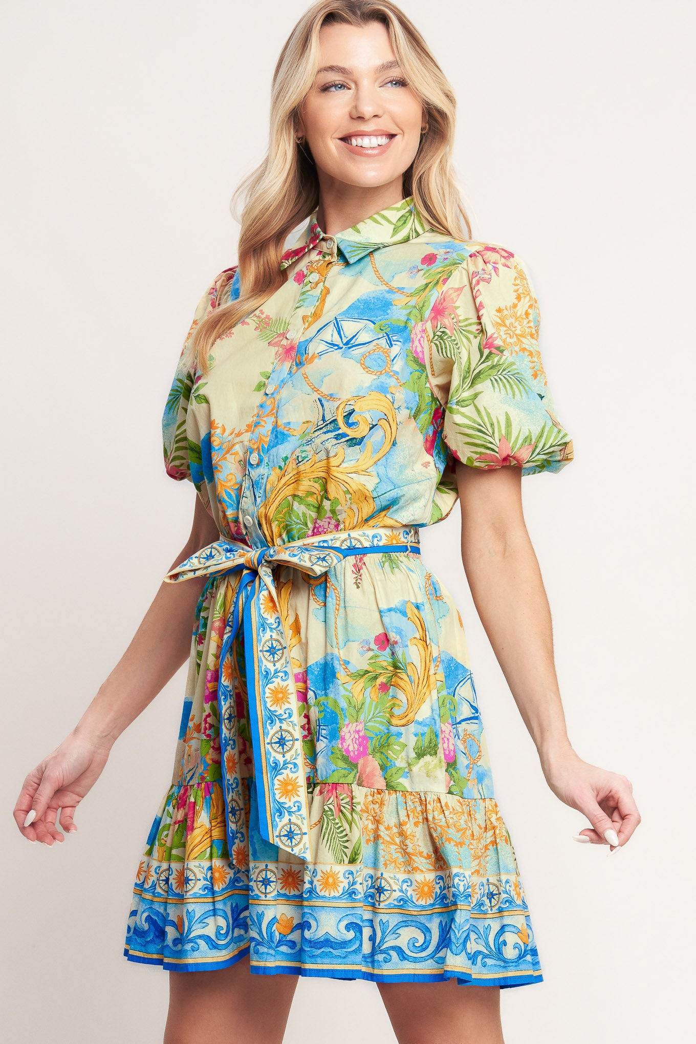 A printed woven mini dress featuring collar, short puff sleeve, front button down, elasticized waist with self sash tie and ruffle hem

Details:

Self: 100% Cotton

Size & Fit

-Model is 5`8" And Wearing Size Small
-Measurements Taken From Size Small
-Approx. Length: 36"