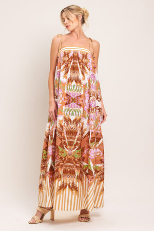 Woman wearing a maxi, patterned, multicolored orange and pink dress | Flying Tomato