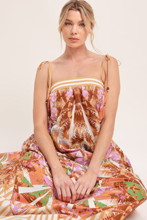 Woman wearing a maxi, patterned, multicolored orange and pink dress | Flying Tomato