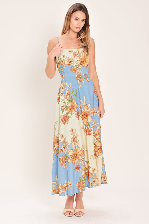 Woman wearing a blue and peach floral midi dress featuring straight neckline, straps, circle skirt and back zipper closure | Flying Tomato
