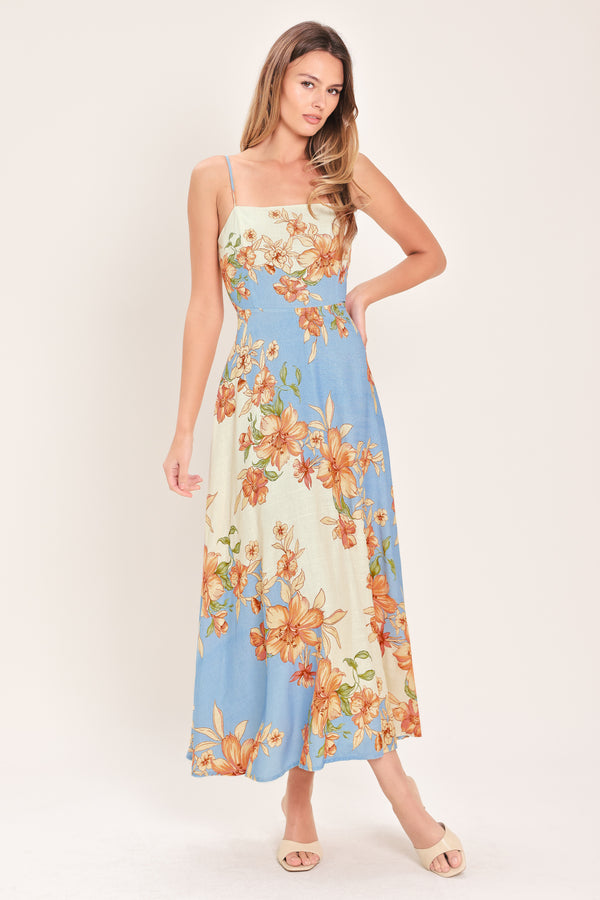 Woman wearing a blue and peach floral midi dress featuring straight neckline, straps, circle skirt and back zipper closure | Flying Tomato
