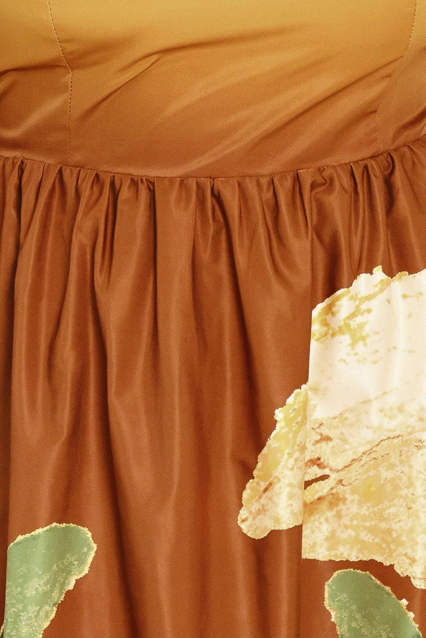 A woman modeling a strapless maxi dress with a mustard yellow top and a brown skirt featuring a large yellow and green floral print | Flying Tomato Curve