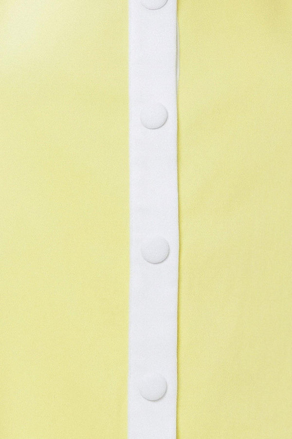 White buttons on a light yellow fabric