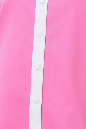 Close-up of a pink garment with a white trim